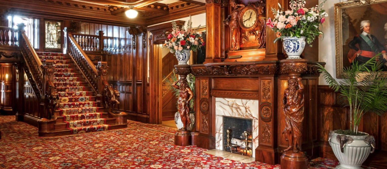 The grand staircase and carved wood interior of the Turnblad Mansion at the American Swedish Institute