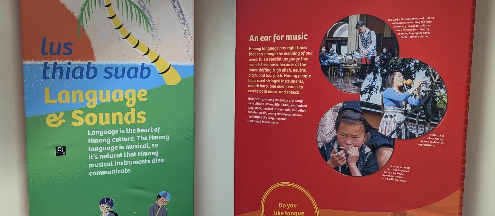 Changing Times exhibit panels about Hmong language, music, and cultural traditions with a Capption indicator