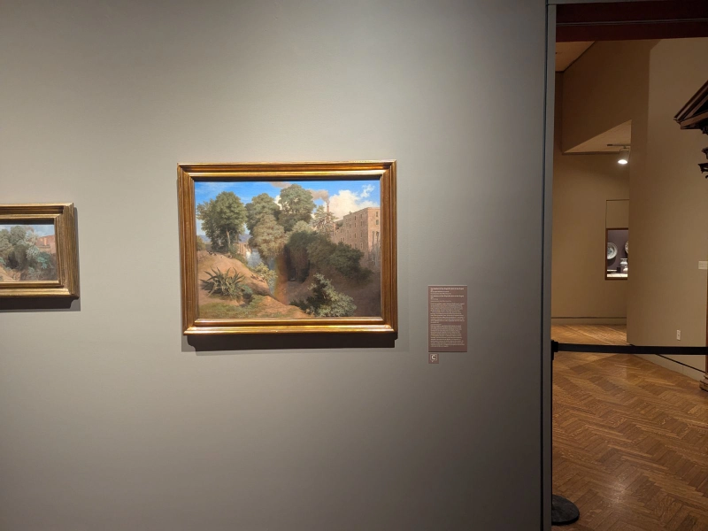 A José María Velasco landscape painting displayed beside a Capption indicator at the Minneapolis Institute of Art