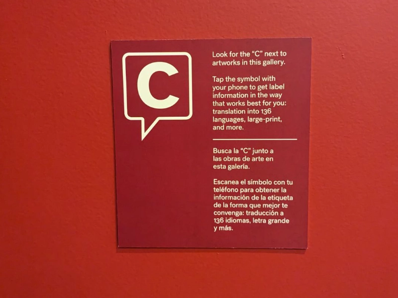 Bilingual gallery instructions explaining how visitors can tap Capption indicators for accessible artwork information