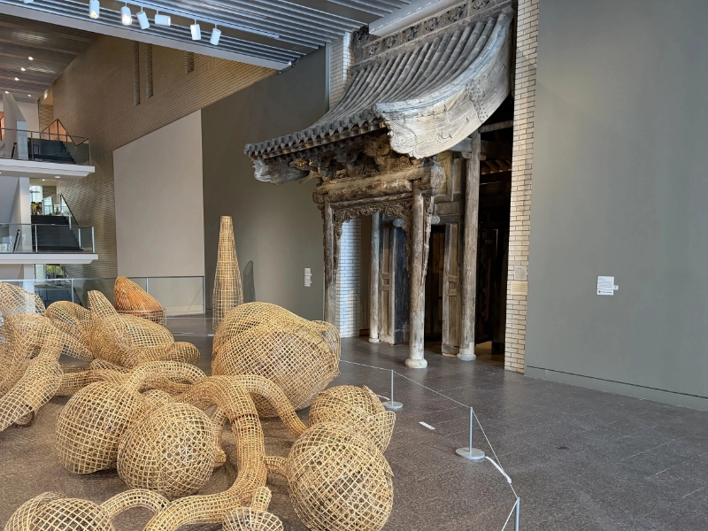 A woven sculpture and historic architectural structure inside the Minneapolis Institute of Art