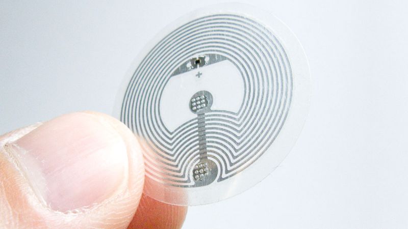 A passive NFC tag — a small circular sticker that activates with a single phone tap